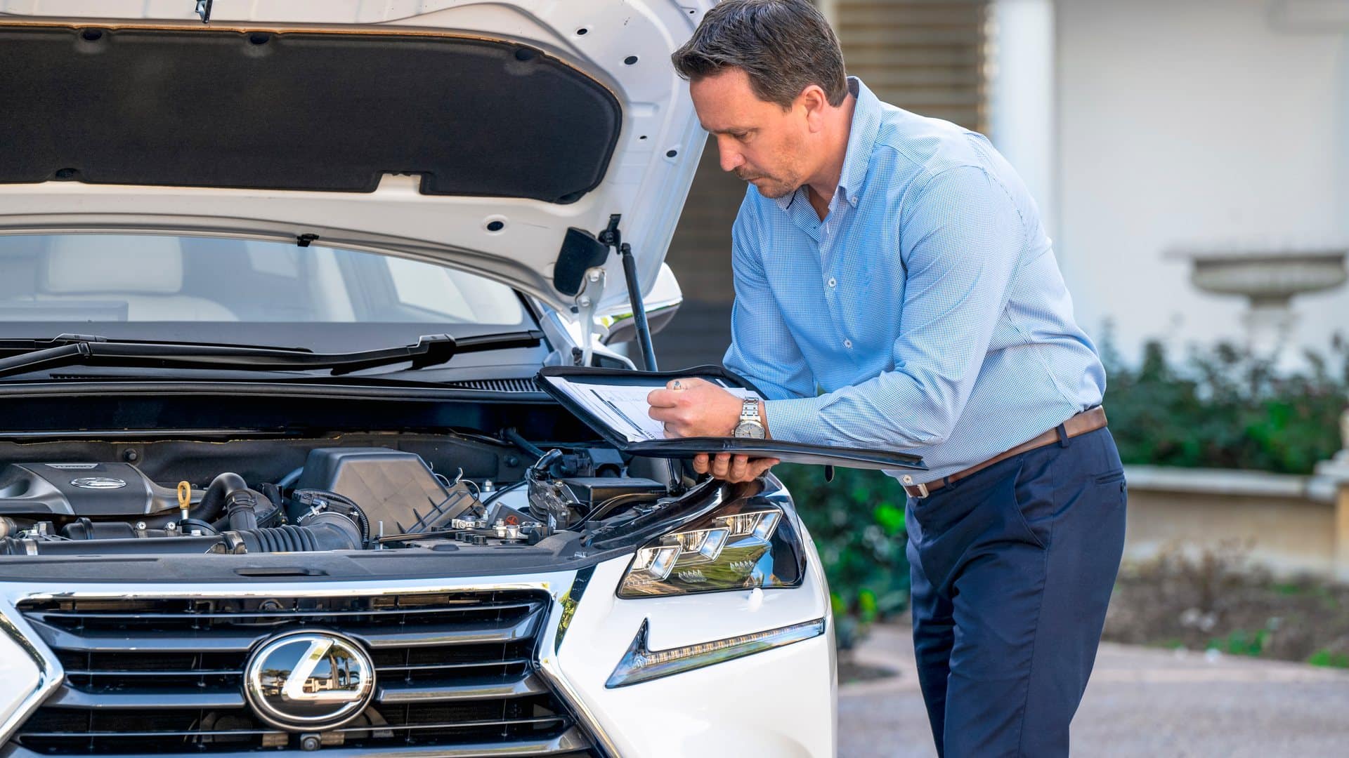 Adam checking over a car's engine